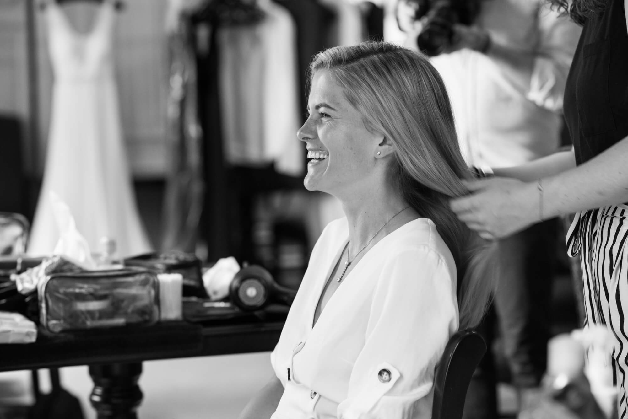 A bride having her hair done at Dartmouth house wedding venue